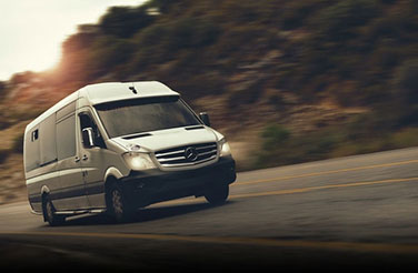 Τransfers: a white van on the road in the Peloponnese