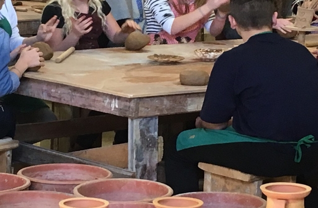 pottery students at table with clay