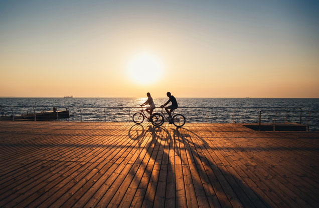 Nafplio Cycling Tour: cyclists at the port of Nafplio at the sunset