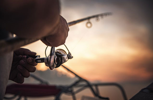 Nafplion Fishing Boat Tour: Man fishing with fishing rod in Nafplion tour