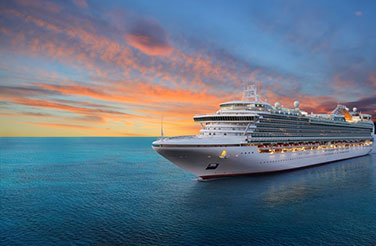 Tours from Cruise Ships: a cruise ship sails in the clear blue waters of the Aegean at sunset
