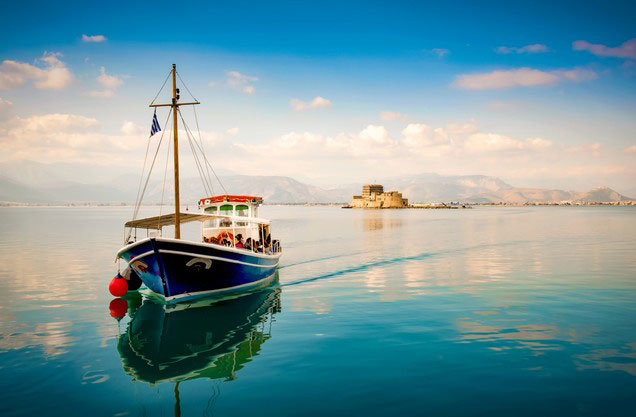 Nafplion to Sparta-Mystras and return: A boat is sailing in the blue waters of the sea in Nafplio