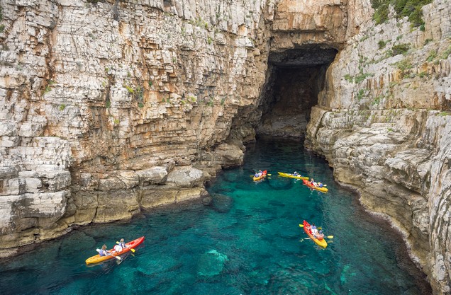canoes in the crystal clear waters of the Kardamyli Sea