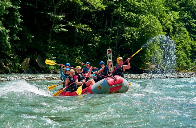 A group of people are rafting on the Lousios River