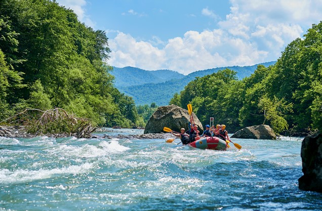 A group of people are rafting on the Lousios River