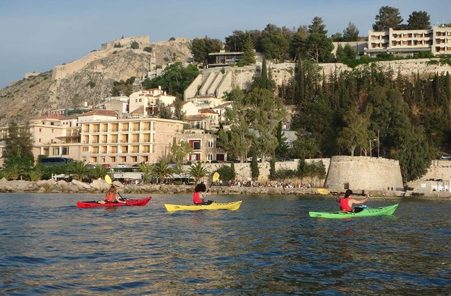 people doing kayak in front of the medieval castles of Nafplio